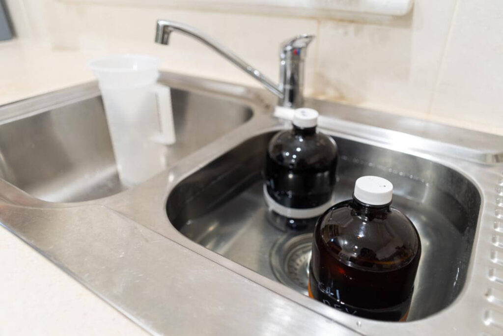 Warming film developing chemicals in kitchen sink
